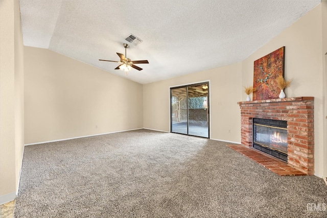 unfurnished living room featuring visible vents, ceiling fan, carpet, lofted ceiling, and a fireplace