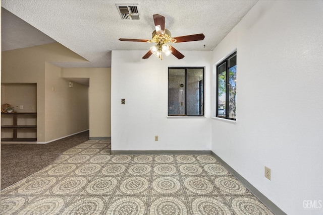 empty room featuring visible vents, baseboards, a textured ceiling, and ceiling fan