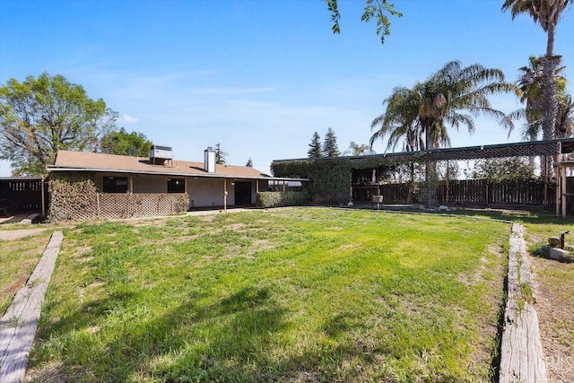 view of yard featuring central AC and fence