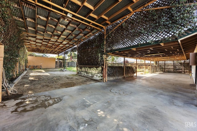 view of patio / terrace with a carport and concrete driveway