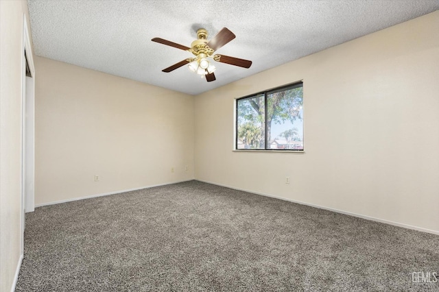 unfurnished room with carpet flooring, a ceiling fan, baseboards, and a textured ceiling