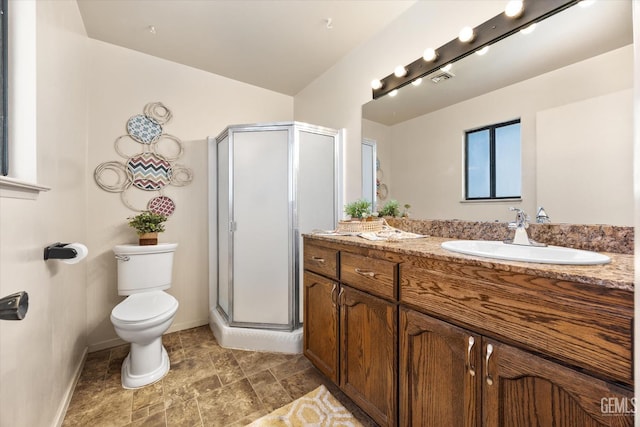 full bathroom with vanity, a shower stall, toilet, and baseboards