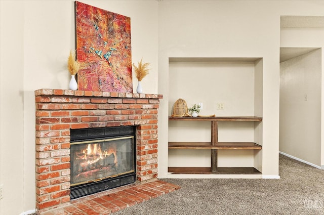 unfurnished living room with a brick fireplace, baseboards, and carpet floors