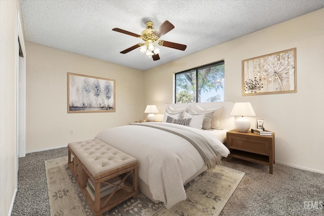 carpeted bedroom with a textured ceiling, baseboards, and a ceiling fan