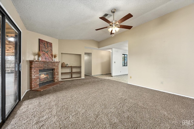 unfurnished living room with carpet flooring, a healthy amount of sunlight, a fireplace, and lofted ceiling