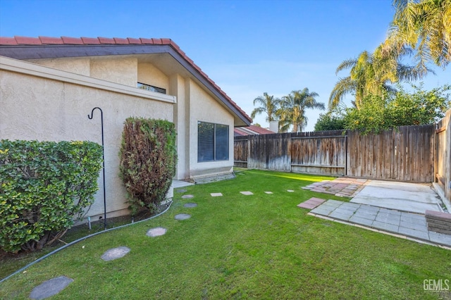 view of yard with a fenced backyard and a patio