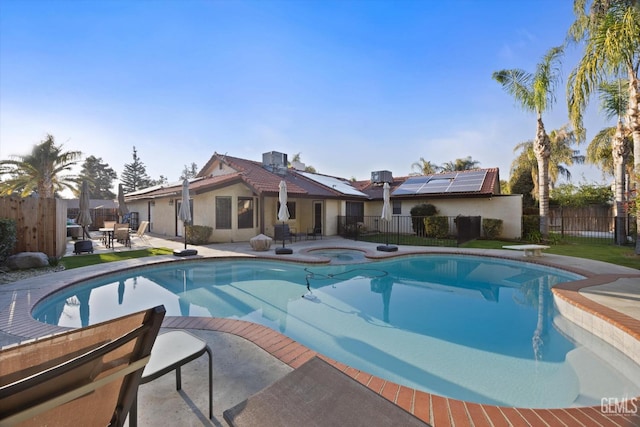 view of pool with a fenced in pool, a patio area, an in ground hot tub, a fenced backyard, and a diving board