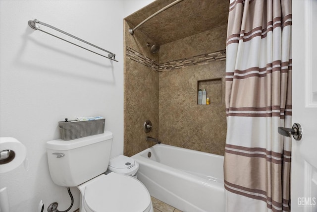 bathroom featuring shower / tub combo and toilet