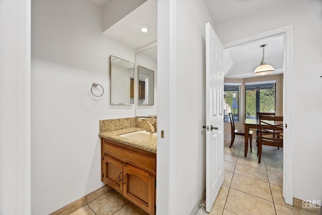 bathroom with vanity, baseboards, and tile patterned floors