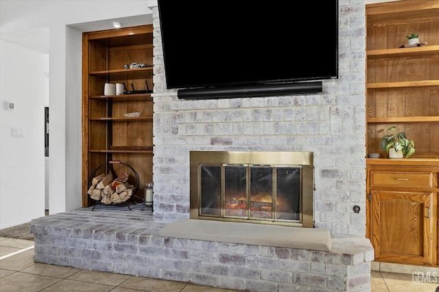 interior details featuring built in features and a brick fireplace