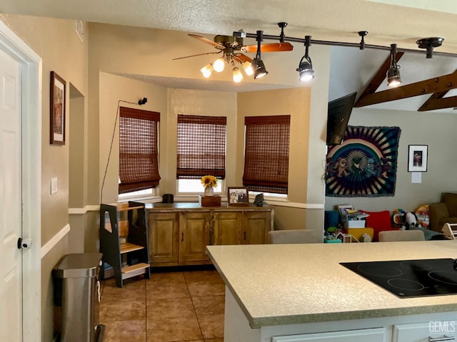 2304 Mountain Oak Rd, Bakersfield, CA 93311 - kitchen featuring black electric stovetop, a ceiling fan, light tile patterned floors, and light countertops