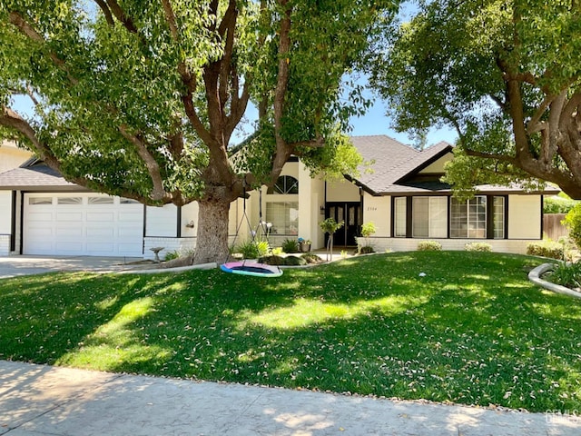 2304 Mountain Oak Rd, Bakersfield, CA 93311 - view of front of house featuring a front lawn, an attached garage, concrete driveway, and stucco siding