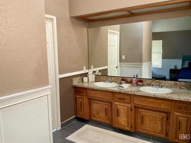2304 Mountain Oak Rd, Bakersfield, CA 93311 - full bathroom with double vanity, tile patterned floors, and wainscoting