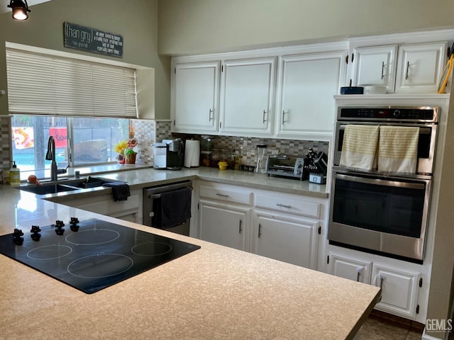 2304 Mountain Oak Rd, Bakersfield, CA 93311 - kitchen featuring black electric cooktop, double oven, decorative backsplash, dishwasher, and white cabinetry