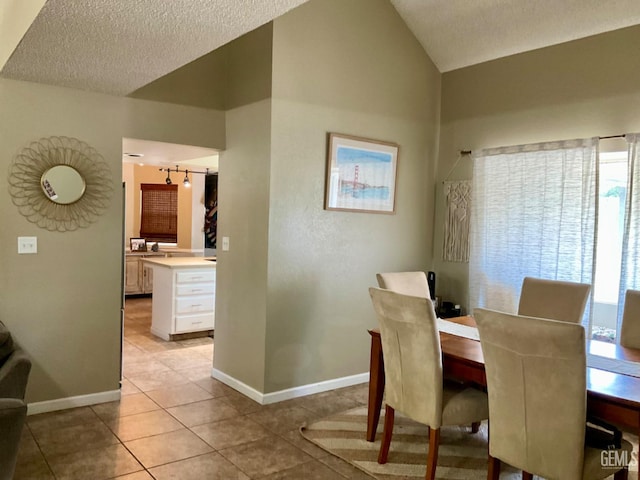 2304 Mountain Oak Rd, Bakersfield, CA 93311 - dining area with light tile patterned floors, lofted ceiling, and a textured ceiling