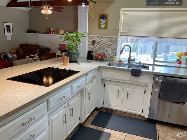 2304 Mountain Oak Rd, Bakersfield, CA 93311 - kitchen with stainless steel dishwasher, black electric stovetop, light countertops, and white cabinetry