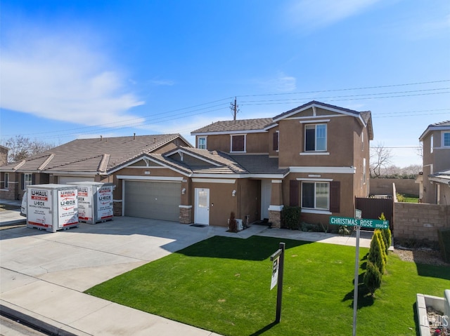 view of front facade with a garage, a front yard, concrete driveway, and stucco siding