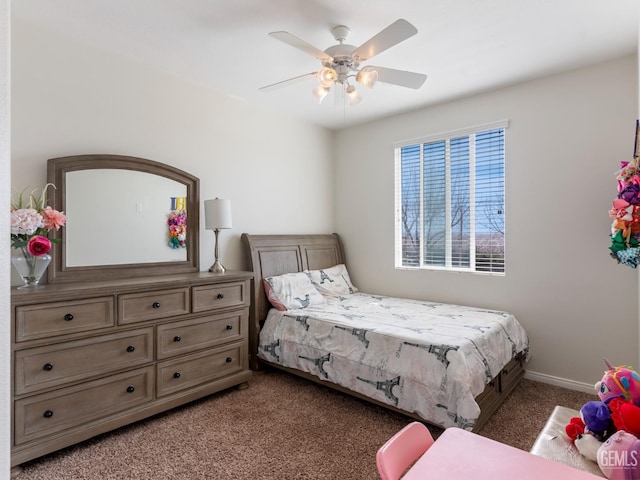 bedroom featuring a ceiling fan, light colored carpet, and baseboards