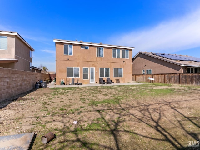 back of property with a patio area, a fenced backyard, and stucco siding