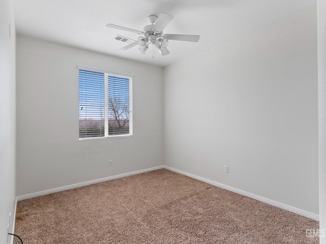 empty room with a ceiling fan, carpet, visible vents, and baseboards