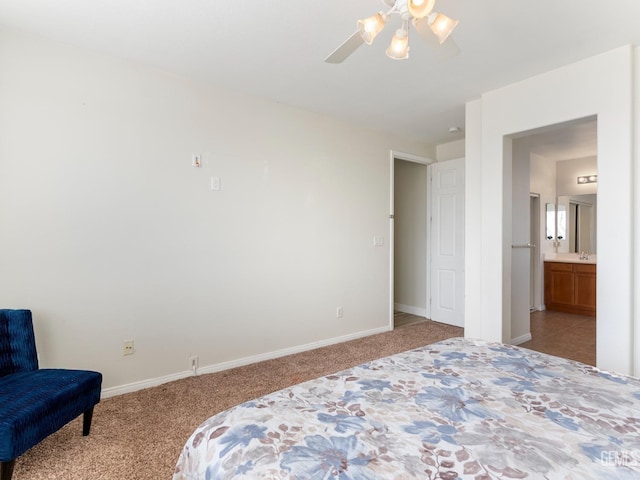 bedroom featuring baseboards, a sink, and light colored carpet