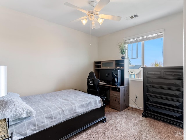 carpeted bedroom featuring visible vents and a ceiling fan