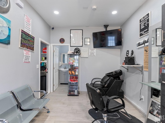 interior space with baseboards, a sink, light wood-style flooring, and recessed lighting