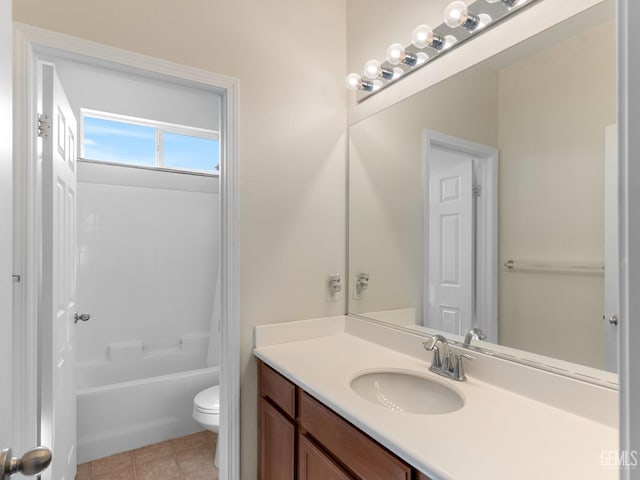 bathroom featuring toilet, tile patterned floors, tub / shower combination, and vanity