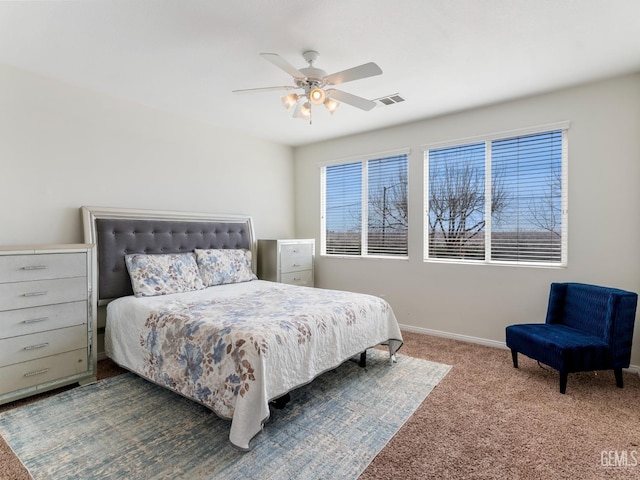 bedroom featuring dark colored carpet, a ceiling fan, visible vents, and baseboards