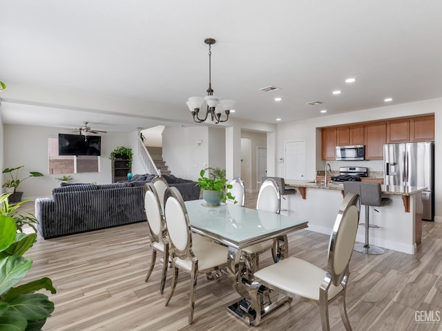 dining room with recessed lighting, visible vents, light wood-style floors, stairs, and baseboards