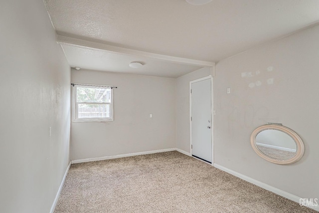 empty room featuring baseboards and carpet