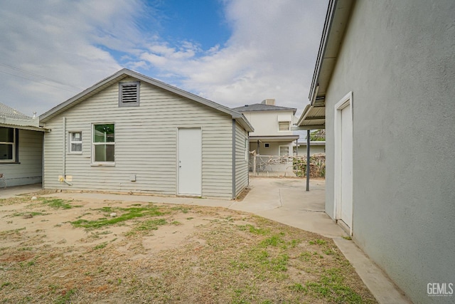 view of home's exterior featuring fence and a patio area