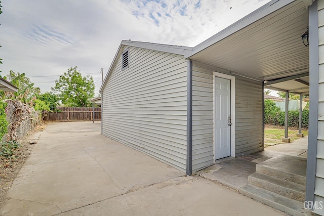 view of outbuilding with fence