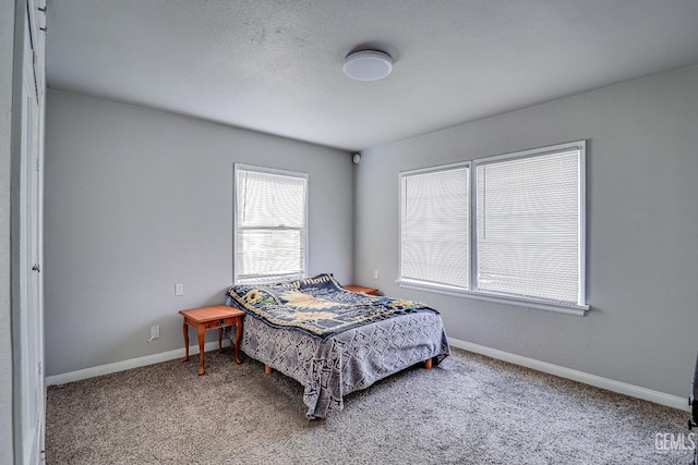 bedroom with carpet floors and baseboards