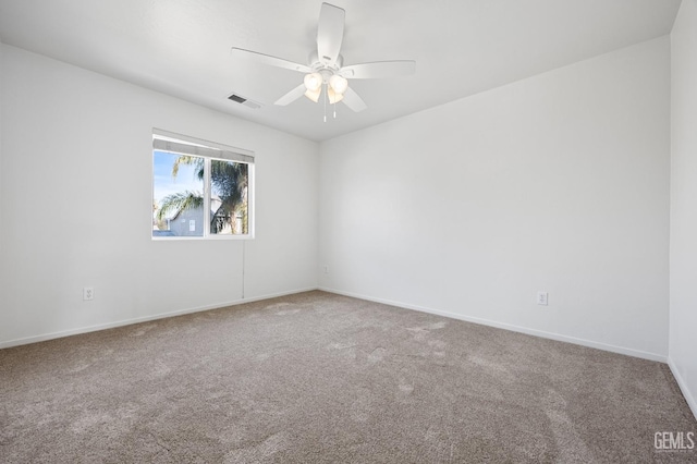 unfurnished room featuring ceiling fan and carpet