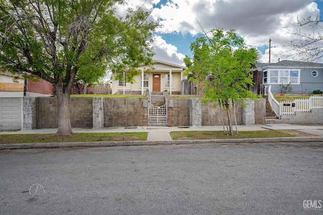 obstructed view of property with a fenced front yard