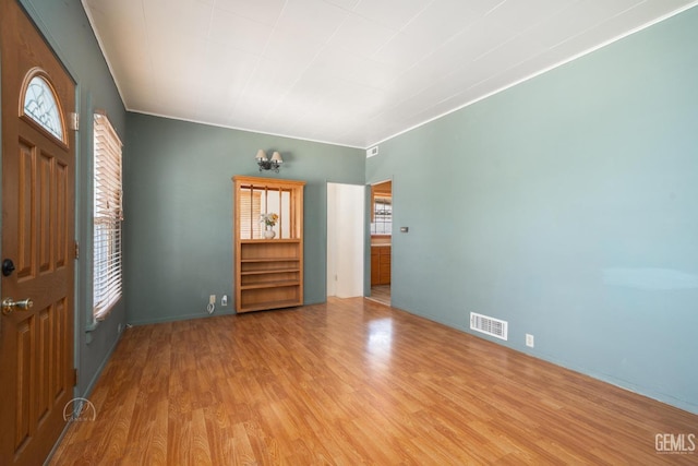 foyer with visible vents and wood finished floors