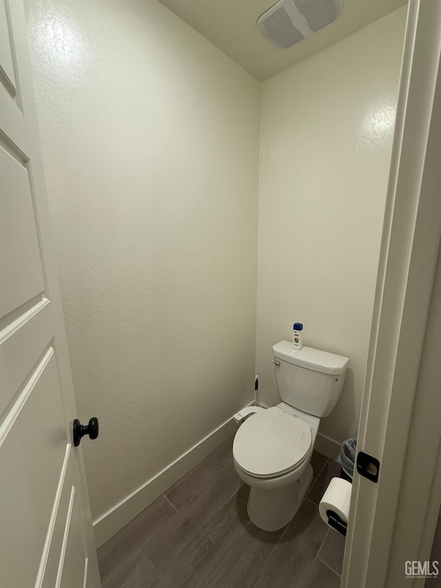 6009 Cardano Ave, Bakersfield, CA 93313 - bathroom with wood finished floors and toilet