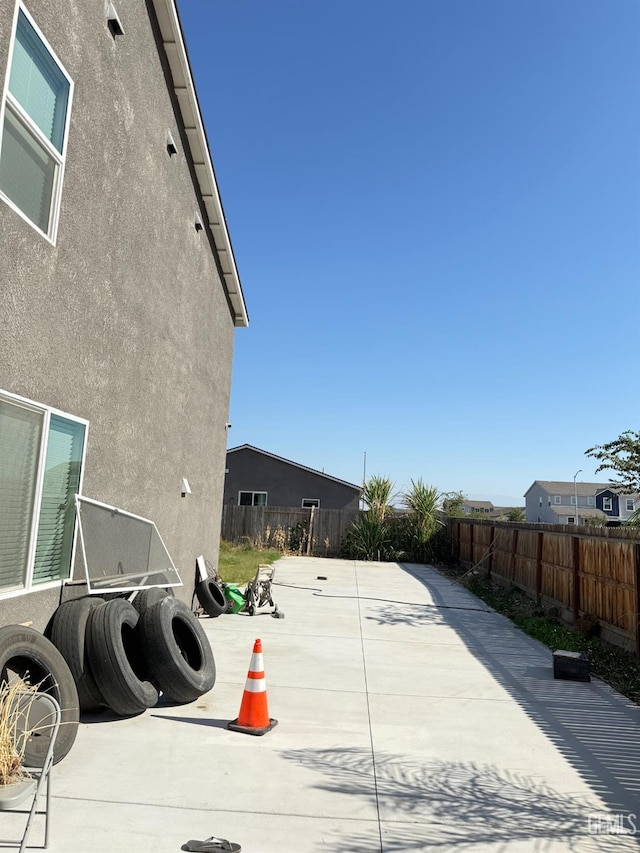 6009 Cardano Ave, Bakersfield, CA 93313 - exterior view of a fenced backyard and stucco siding