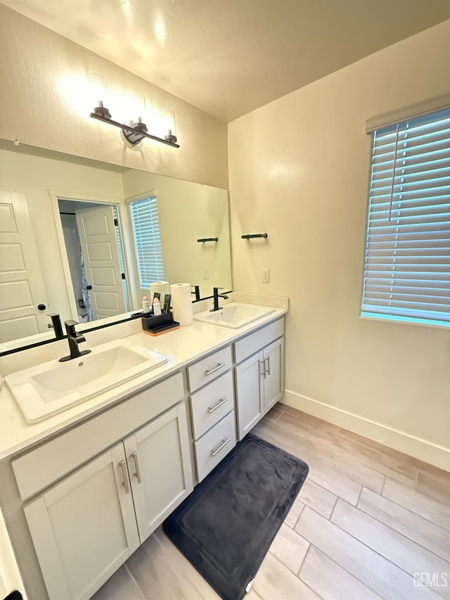 6009 Cardano Ave, Bakersfield, CA 93313 - full bathroom featuring double vanity and wood finish floors