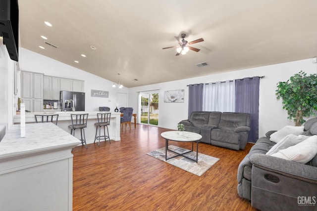 living room with vaulted ceiling, ceiling fan, and hardwood / wood-style floors