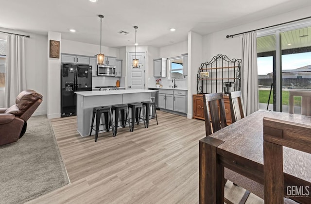 6607 Wind Wolfs Ln, Bakersfield, CA 93313 - dining area featuring light wood finished floors and recessed lighting