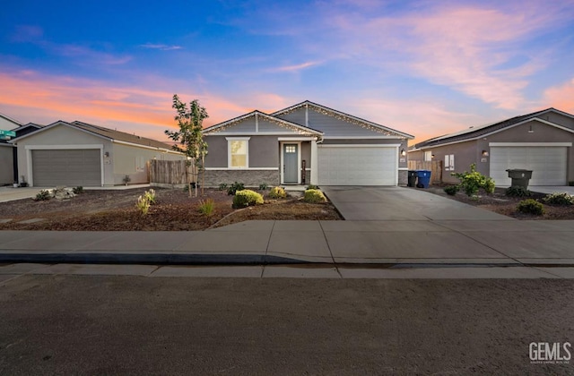6607 Wind Wolfs Ln, Bakersfield, CA 93313 - ranch-style home featuring an attached garage, concrete driveway, and stucco siding