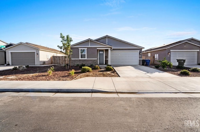 6607 Wind Wolfs Ln, Bakersfield, CA 93313 - view of front of house with driveway, an attached garage, stucco siding, and stone siding