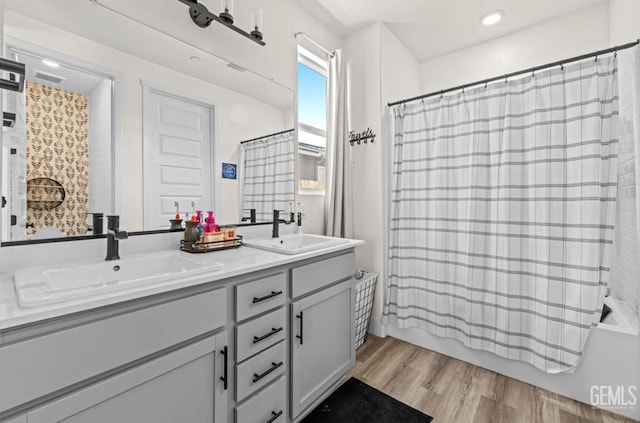 6607 Wind Wolfs Ln, Bakersfield, CA 93313 - full bathroom with double vanity, shower / bath combination with curtain, wood finished floors, and recessed lighting