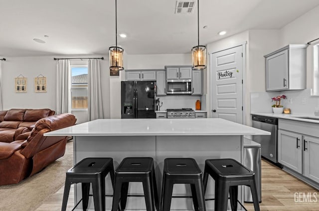6607 Wind Wolfs Ln, Bakersfield, CA 93313 - kitchen featuring appliances with stainless steel finishes, gray cabinets, open floor plan, and recessed lighting