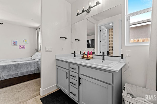 6607 Wind Wolfs Ln, Bakersfield, CA 93313 - full bath with connected bathroom, double vanity, and wood finished floors