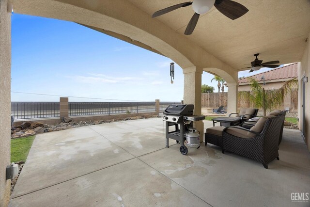 view of patio with a fenced backyard, ceiling fan, and area for grilling