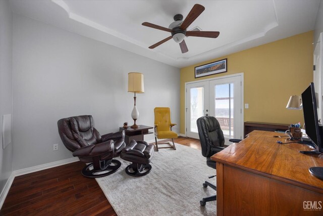 office area with a raised ceiling, french doors, a ceiling fan, baseboards, and wood finished floors