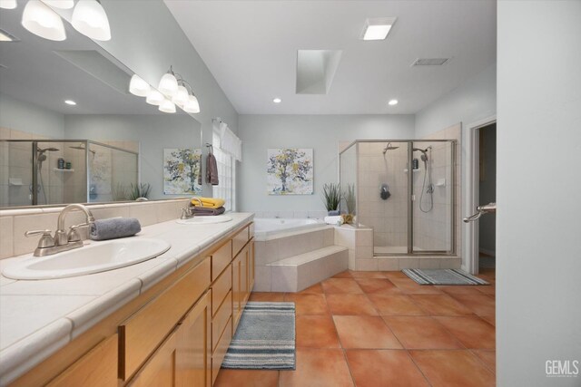 full bathroom with a sink, a bath, and a stall shower